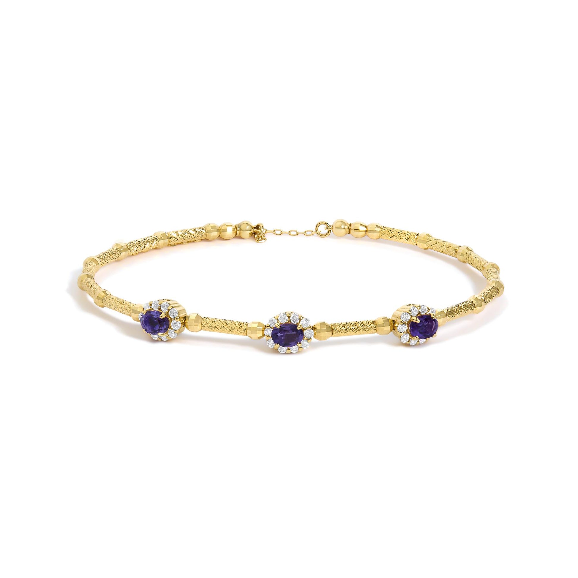 Close-up front angle of a yellow bracelet on a white background, featuring textured and smooth links with purple oval gemstones surrounded by white round gemstones in prong settings.