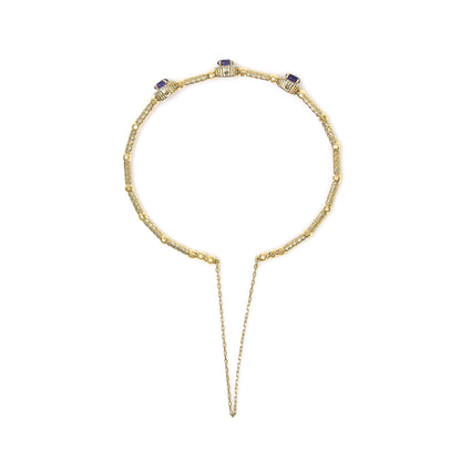 Top-down view of a yellow bracelet featuring three purple oval gemstones in prong settings, surrounded by round white gemstones in prong settings, shown on a white background.