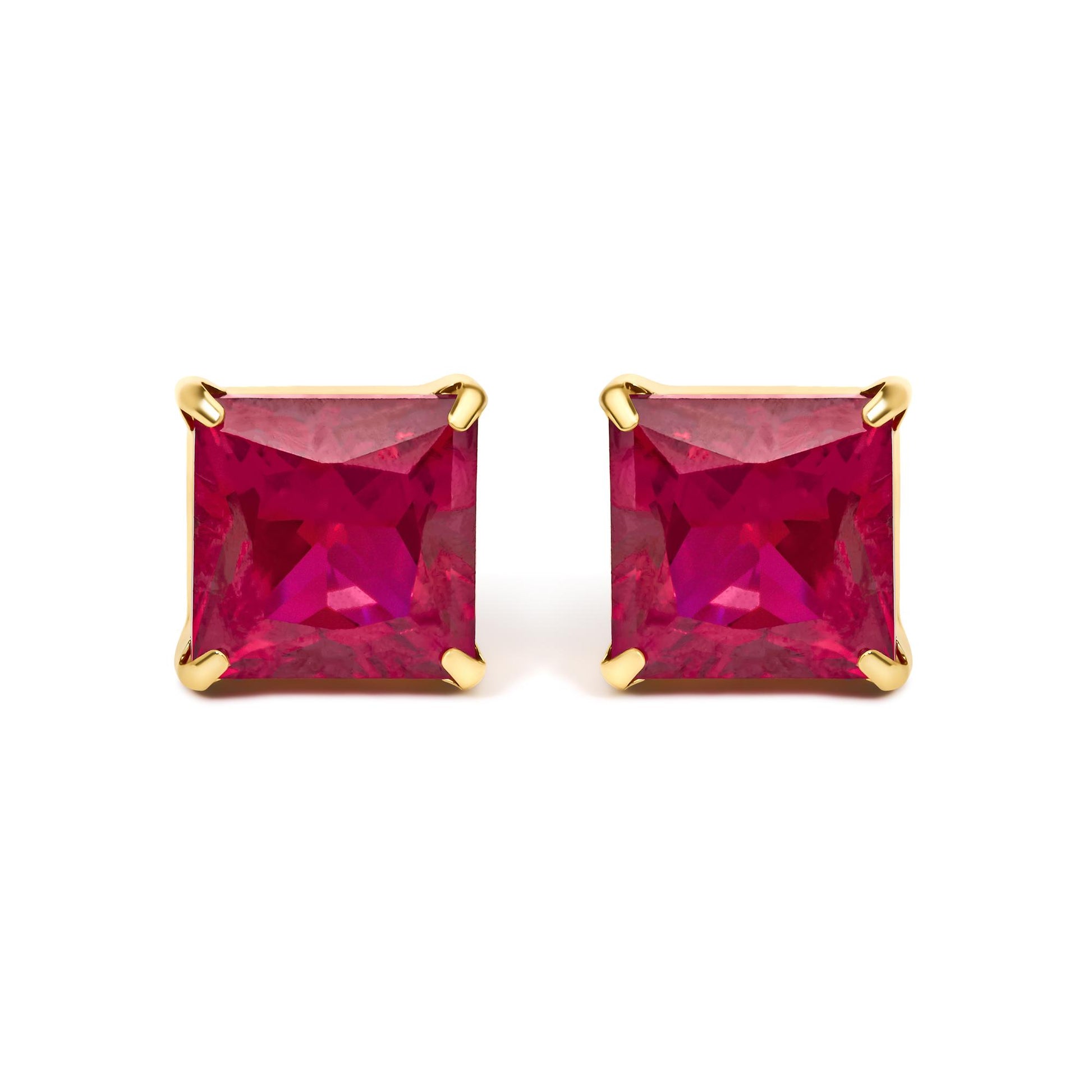 Close-up front view of yellow metal earrings featuring red princess-shaped gemstones in four-prong settings.