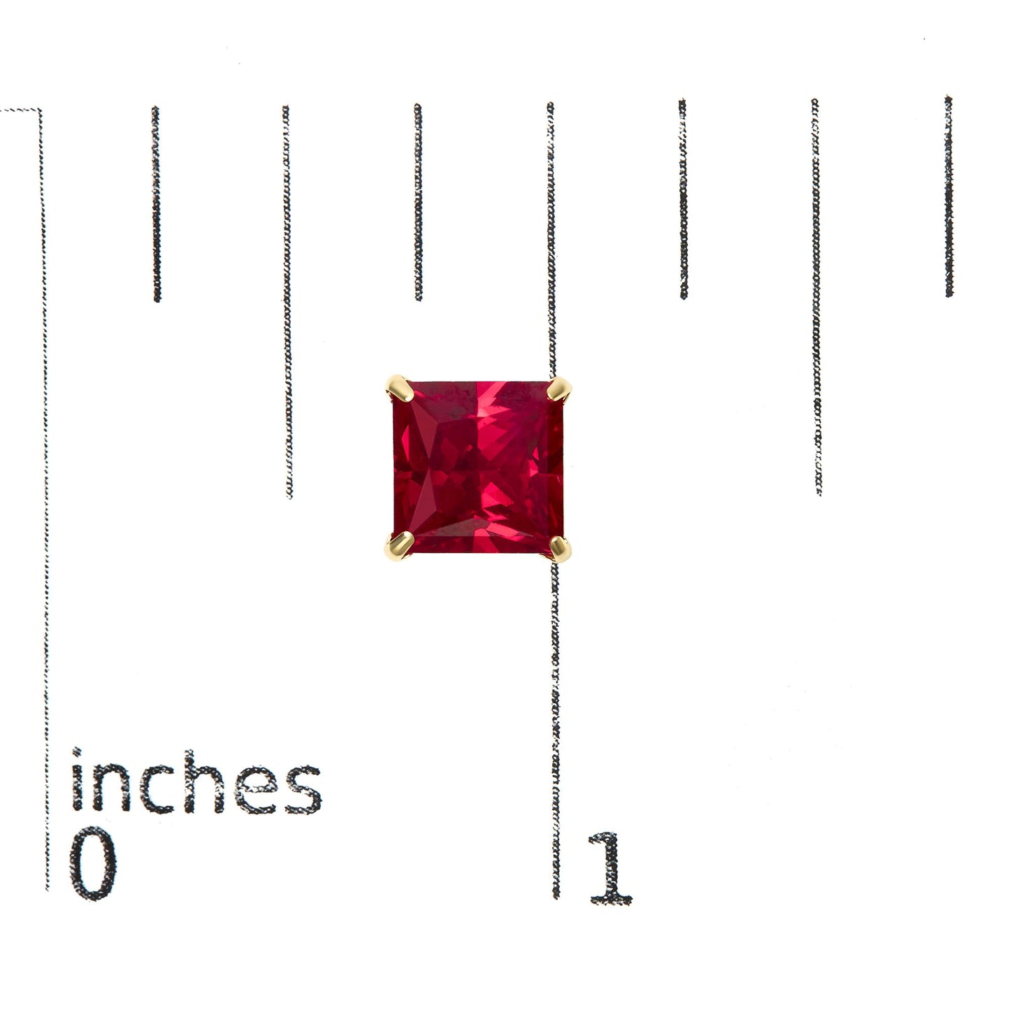 Close-up front view of yellow metal stud earring featuring a princess-shaped red gemstone in a 4-prong setting, shown on a scale.