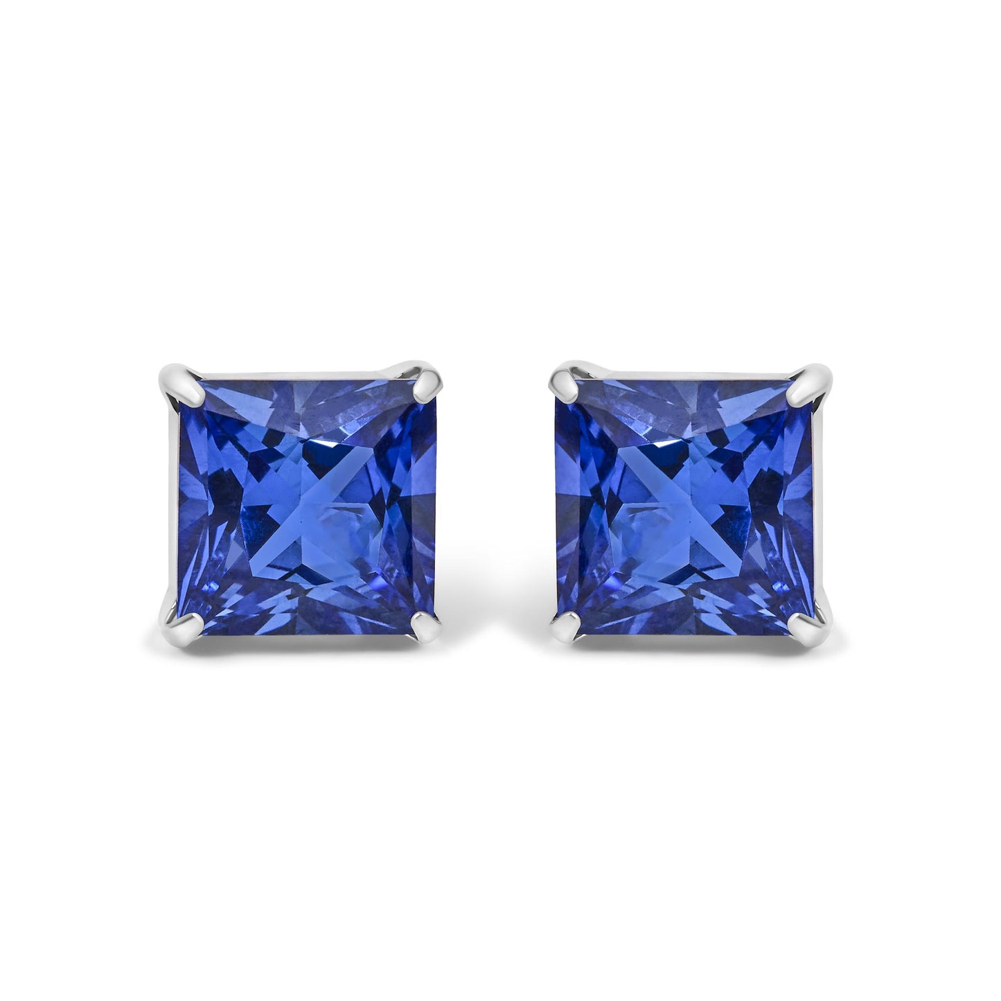 Pair of white metal earrings shown from the front with square-shaped blue gemstones in four-prong settings.