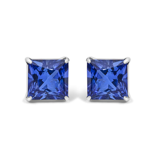 Pair of white metal earrings shown from the front with square-shaped blue gemstones in four-prong settings.