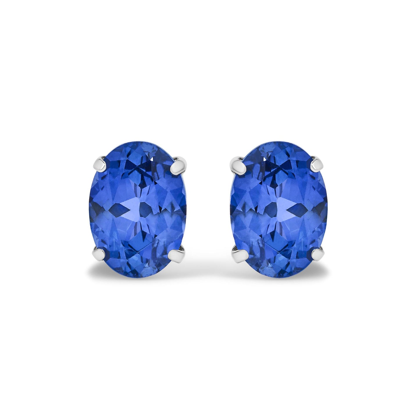 Close-up front view of white metal earrings, each featuring an oval blue gemstone in a four-prong setting.