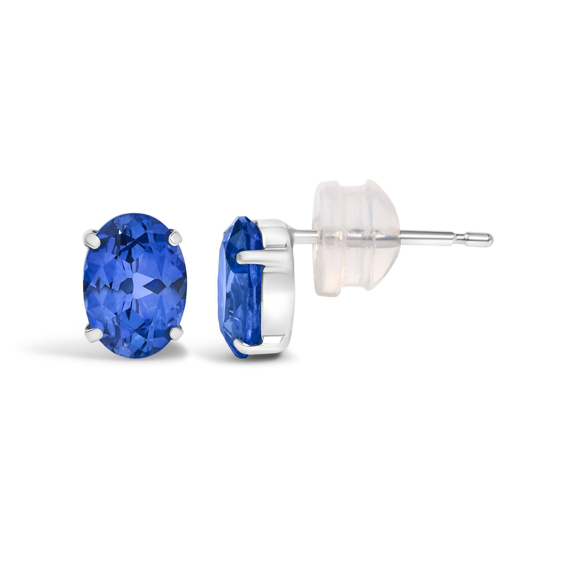 Close-up side and front angle of white metal stud earrings featuring oval-shaped blue gemstones in four-prong settings.