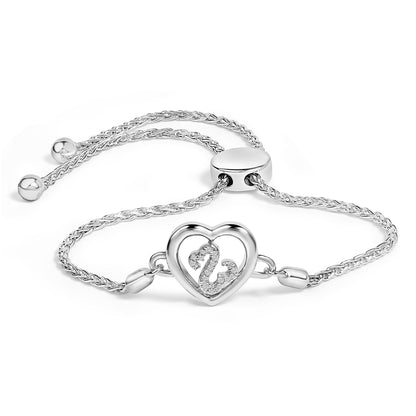 Bracelet with a braided chain and a heart-shaped centerpiece featuring a swan design accented with round white gemstones, shown at a slight angled top view on a white background.