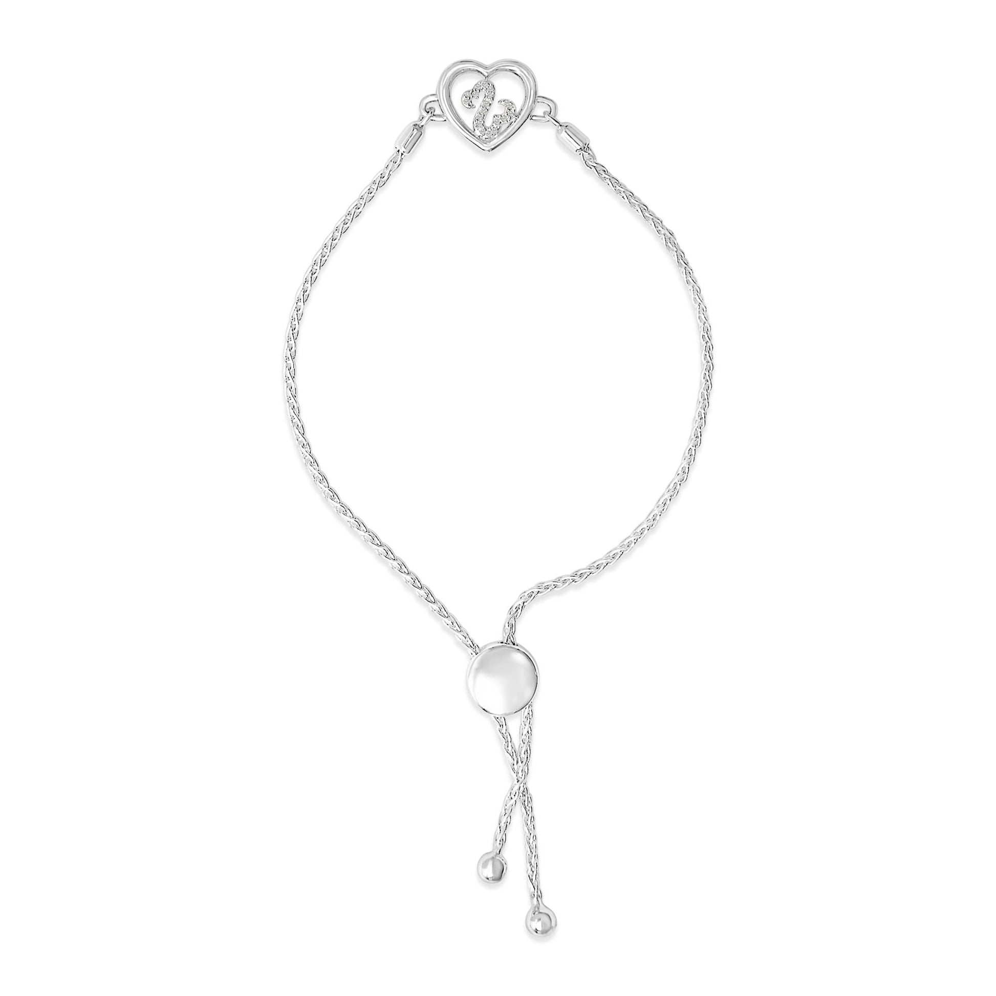 White metal bracelet with a braided chain design, featuring a heart-shaped centerpiece with white round gemstones in a prong setting, shown from a top-down angle.
