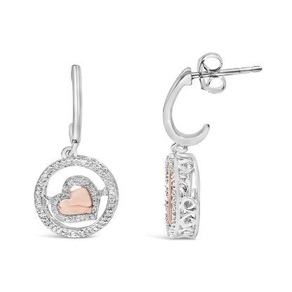 Front and side view close-up of white and rose metal drop earrings featuring a circular design with a rose heart shape in the center surrounded by small white gemstones in a prong setting.