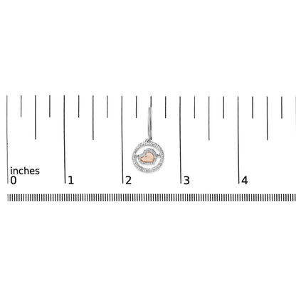 Earring with a rose heart shape surrounded by two concentric white metal circles set with round white gemstones, shown on a ruler scale from a front angle.