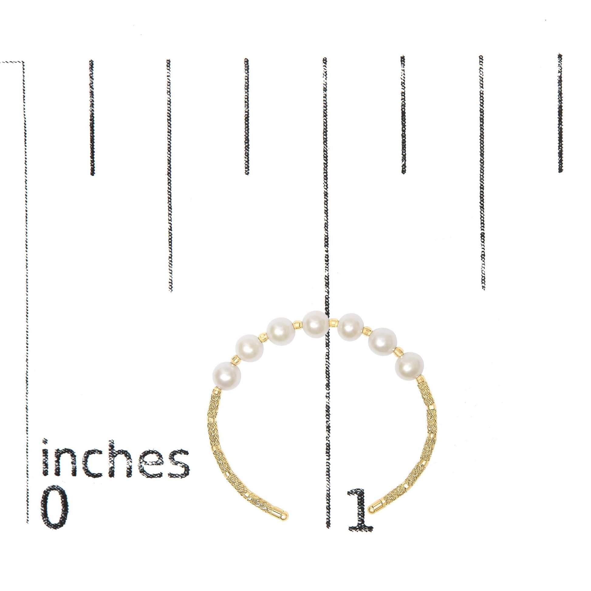 Yellow metal bracelet with pearl-like white gemstones strung along top half, shown on a scale, angled flat overhead.