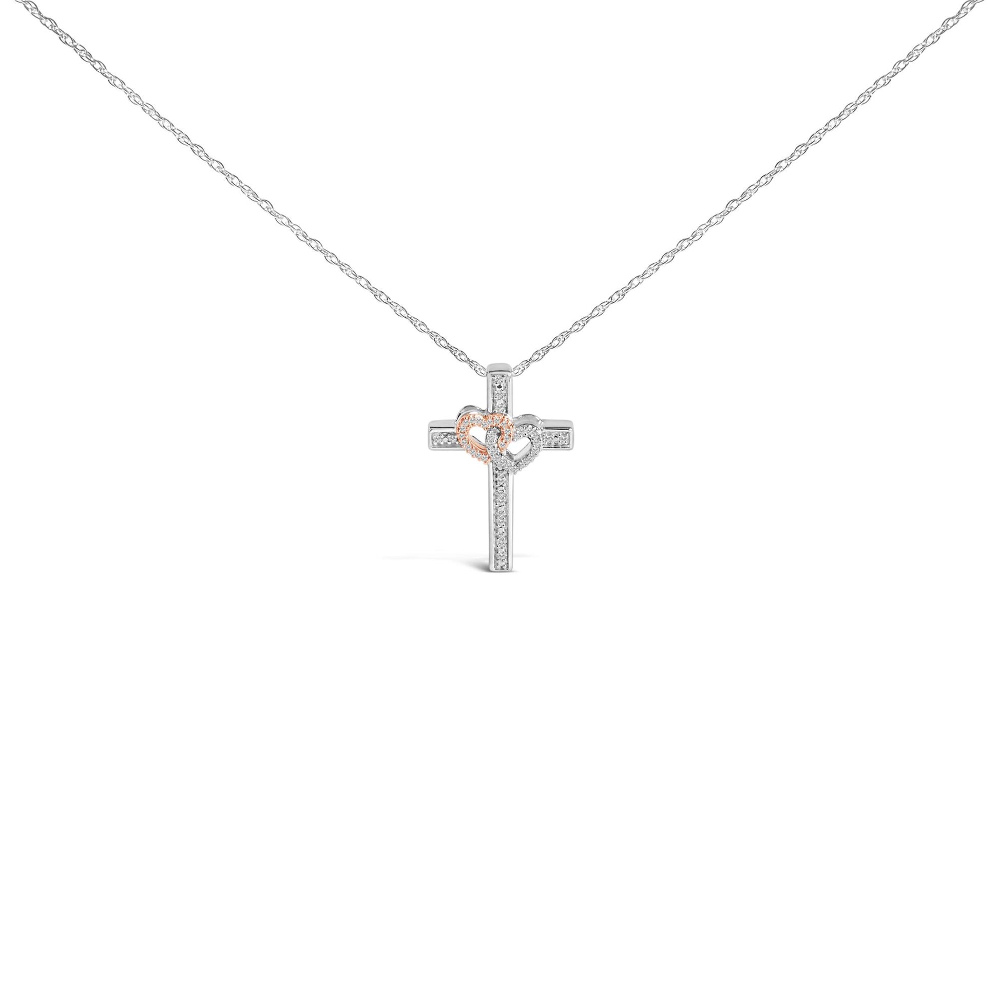 Front view of a necklace with a cross pendant featuring two connected hearts; one heart is outlined in rose color and the other in white, both adorned with small white gemstones in a pave setting.