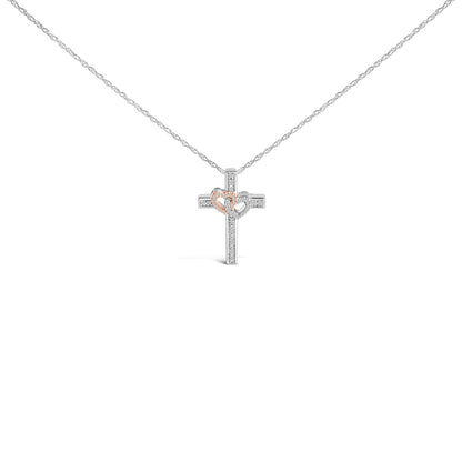 Front view of a necklace with a cross pendant featuring two connected hearts; one heart is outlined in rose color and the other in white, both adorned with small white gemstones in a pave setting.