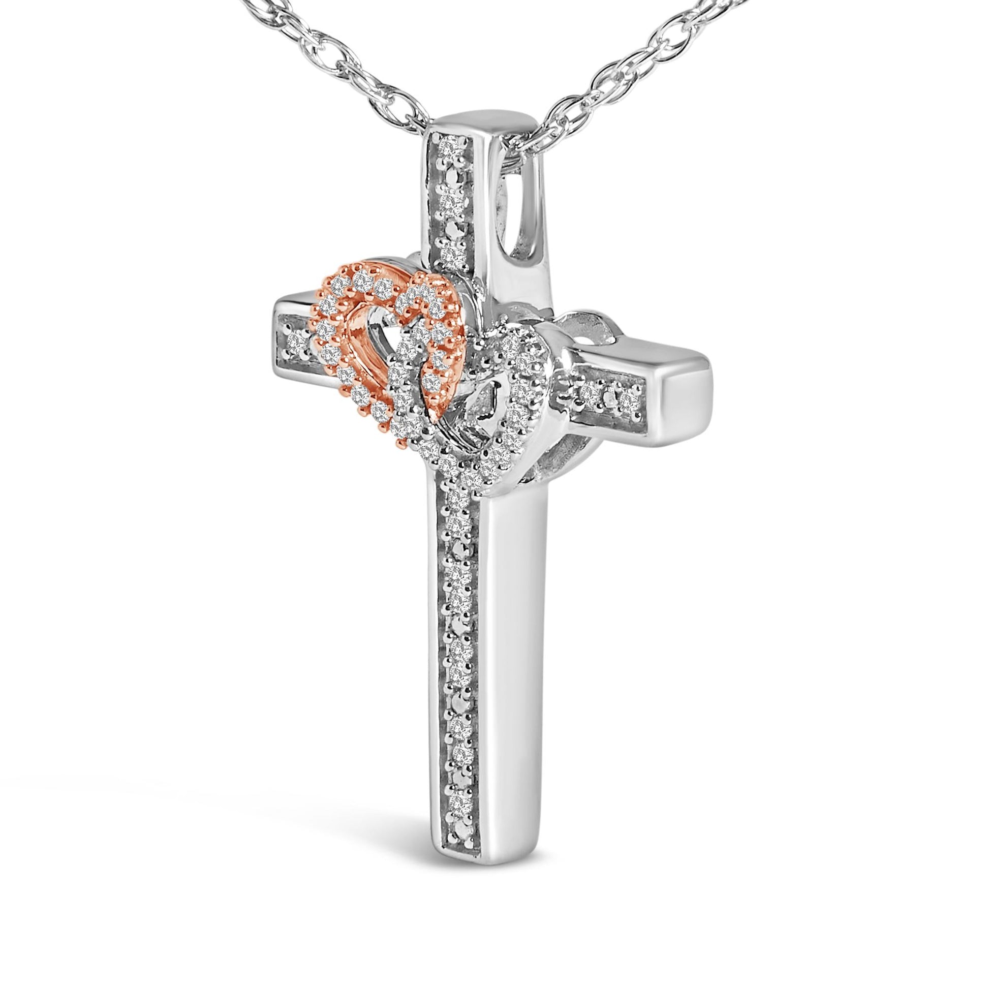 Close-up front angle of a necklace pendant featuring a white cross with pave-set white gemstones and two interlocking hearts, one in rose metal and the other in white metal, both adorned with pave-set white gemstones.
