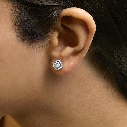 Close-up side view of a white metal square-shaped stud earring with white round gemstones and princess-shaped gemstones in an invisible setting, shown worn on a model.