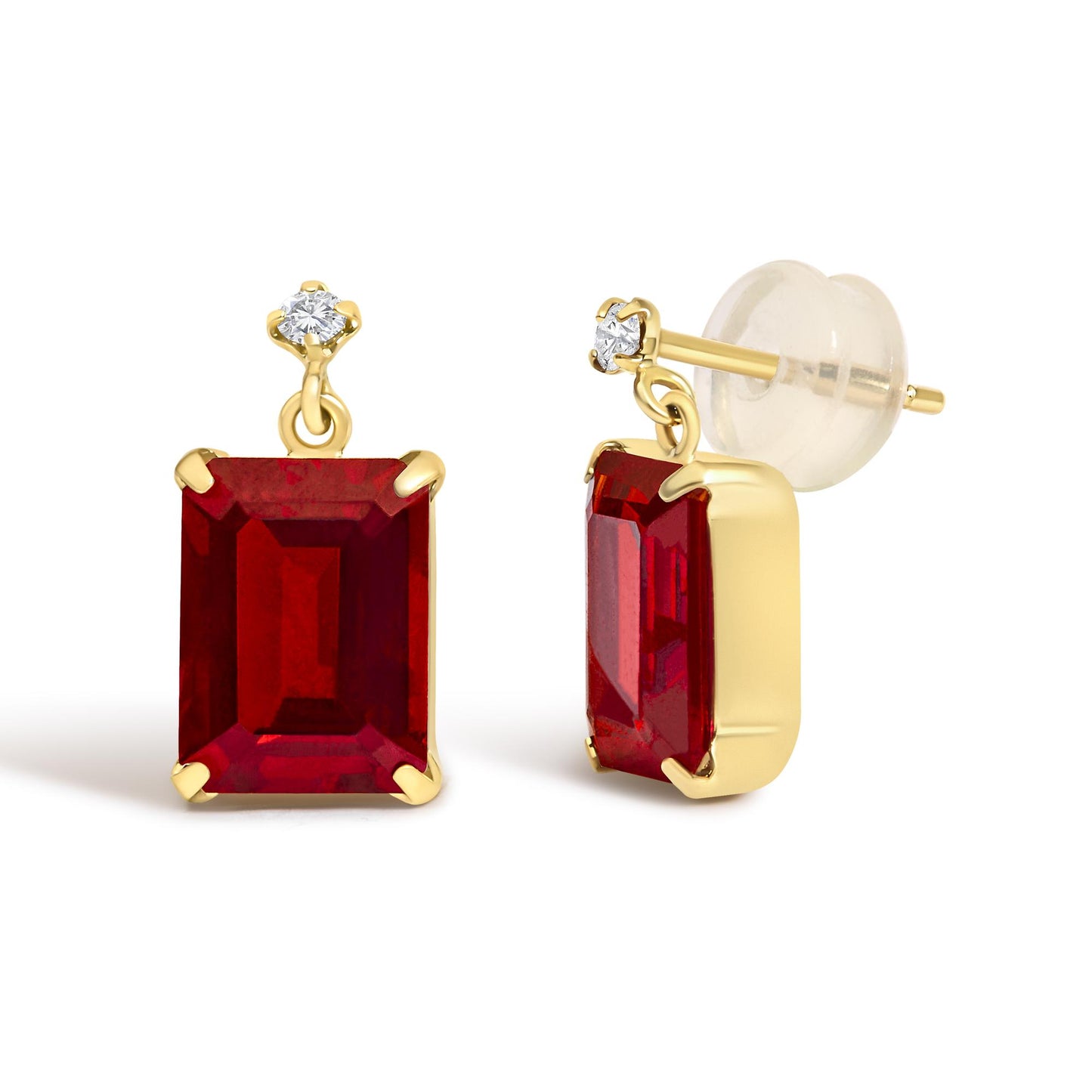 Close-up angled view of yellow metal earrings featuring a red emerald-shaped gemstone in a four-prong setting, topped with a round white gemstone in a four-prong setting, shown on a white background.