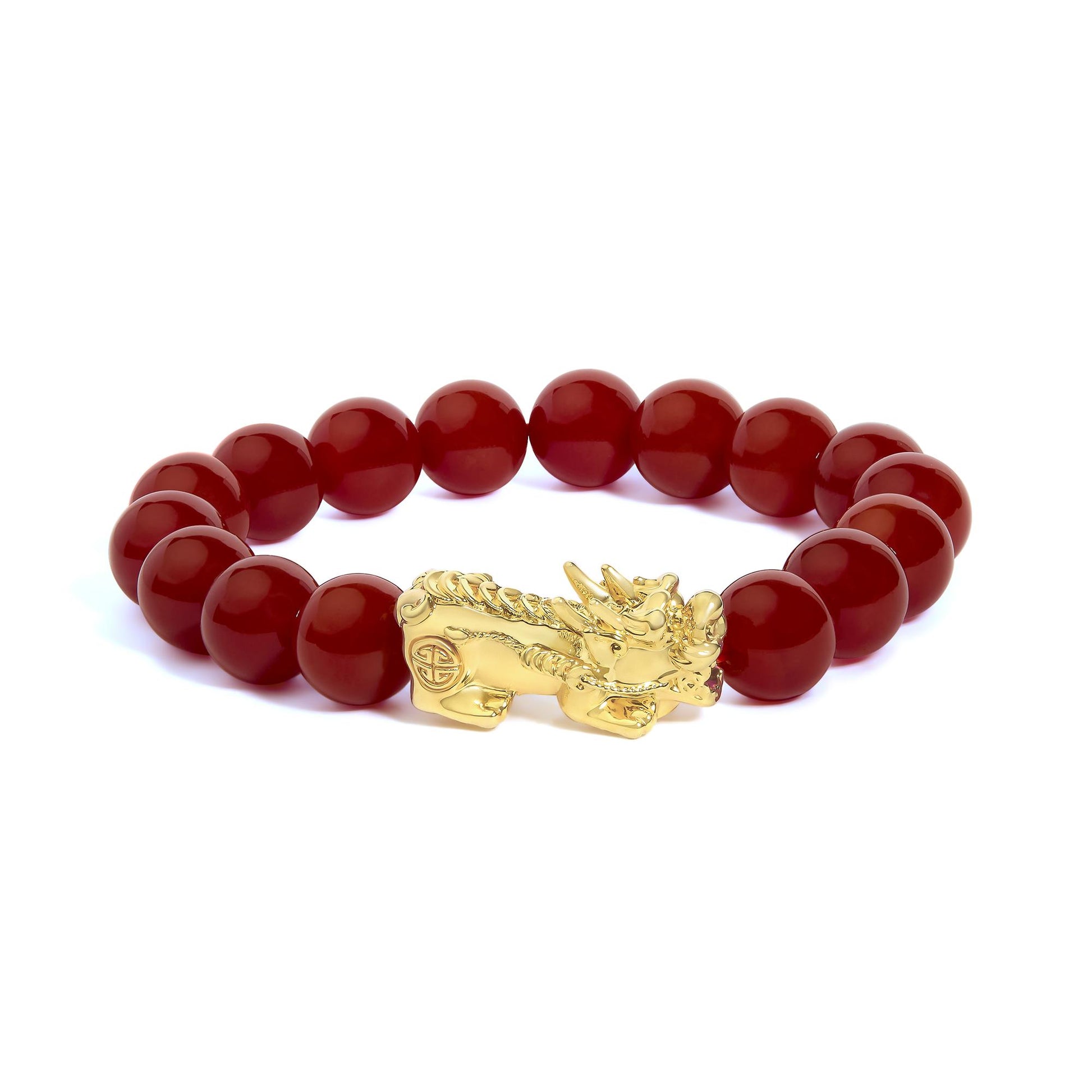 Close-up image of a yellow metal bracelet with round red gemstone beads and an ornate dragon-shaped clasp, shown on a white background from a side angle.