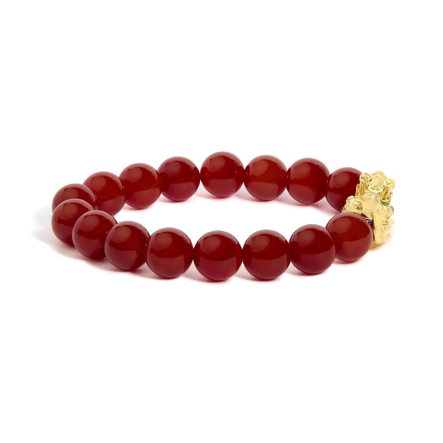 Yellow metal bracelet with round red gemstone beads in a drilled setting, shown in a close-up shot on a white background.