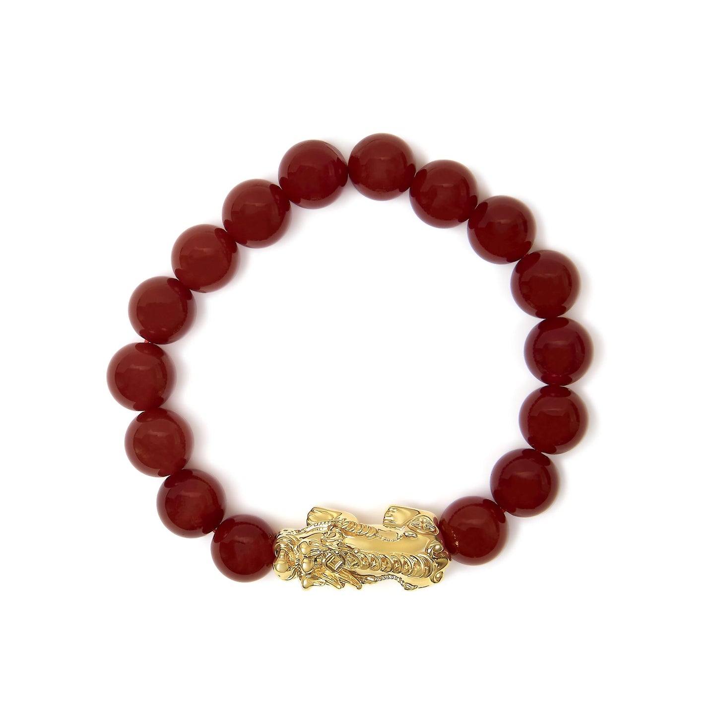Close-up top view of a yellow metal bracelet with round red gemstone beads and an ornate clasp.