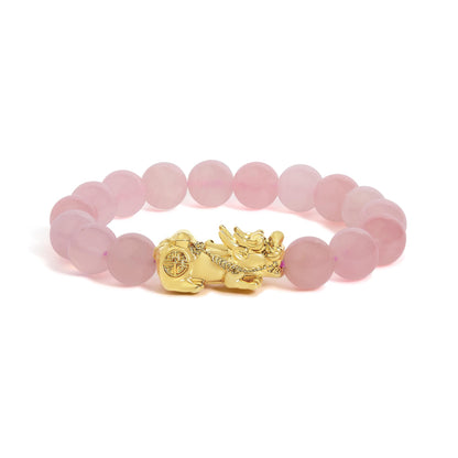 Close-up front angle of a circular bracelet featuring round pink gemstones with a yellow metal decorative element. The bracelet is shown on a white background.