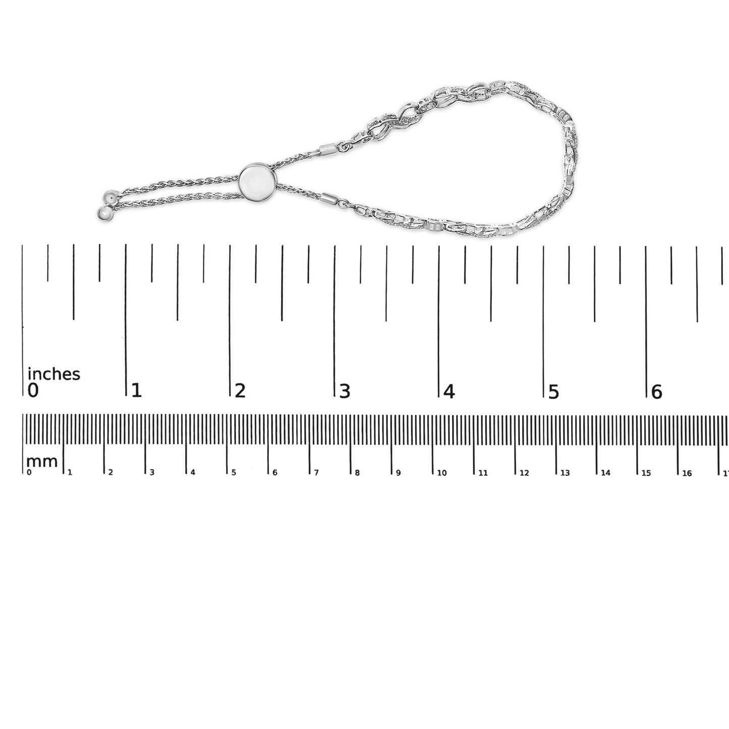 White metal bracelet with round white gemstones in prong settings, shown on a scale from a top-down angle.