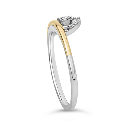 Close-up front angle of a two-tone ring with white and yellow metals, featuring one round white gemstone in a three-prong setting and a curved row of round white gemstones in shared prong settings.