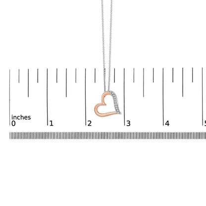 Close-up front view of a heart-shaped necklace pendant in white and rose metal colors, with one side featuring white round pave-set gemstones, shown hanging on a measuring scale.