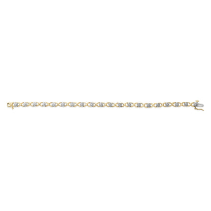 Straight-on shot of a yellow and white metal bracelet with an alternating crisscross design featuring round white gemstones in prong settings.