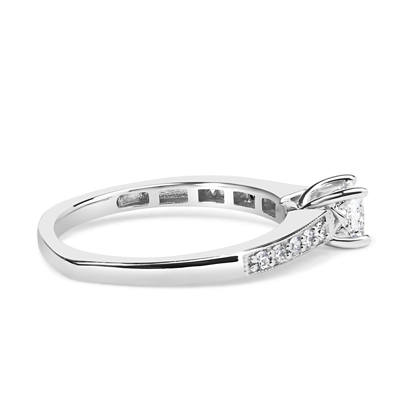 Side angle view of a white metal ring featuring a princess-shaped gemstone in a four-prong setting and multiple round gemstones in a shared prong setting along the band.