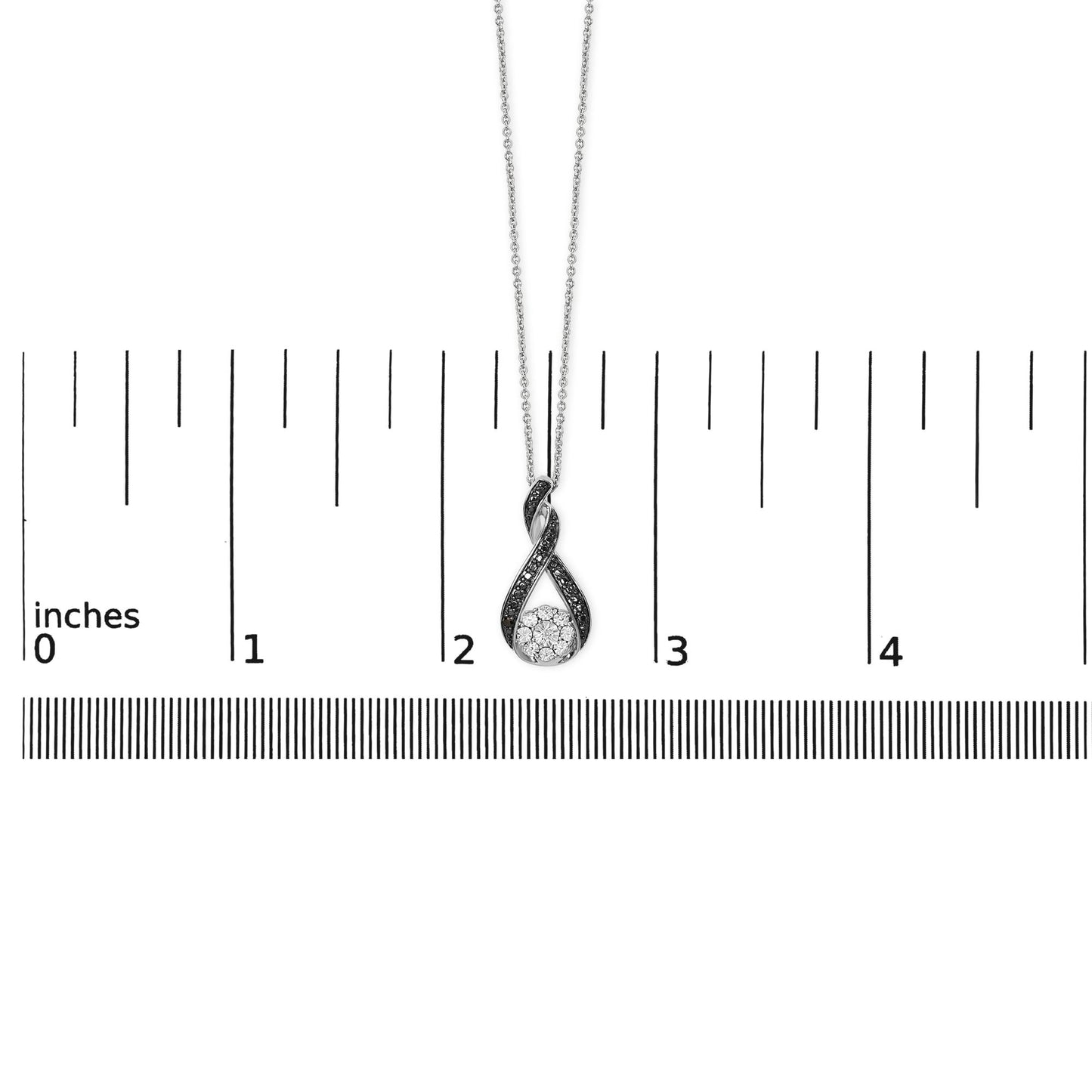 White and black metal twisted teardrop-shaped necklace with black pave-set round gemstone accents and a cluster of white miracle-set round gemstones at the bottom, shown on a ruler scale from front angle.