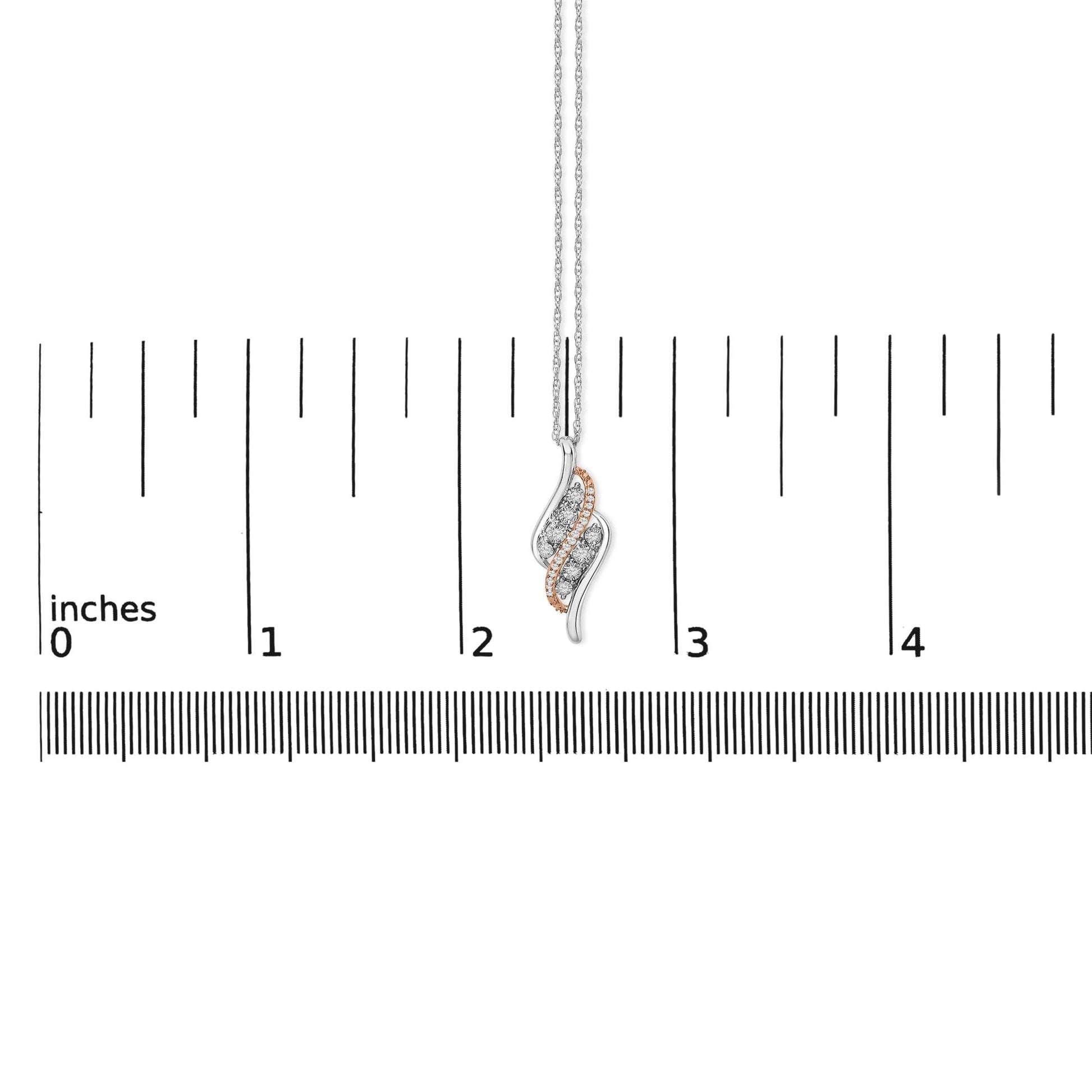 Necklace shown on a scale, featuring a pendant with intertwined white and rose metal curves, accented with round white gemstones in prong settings, front-facing angle.