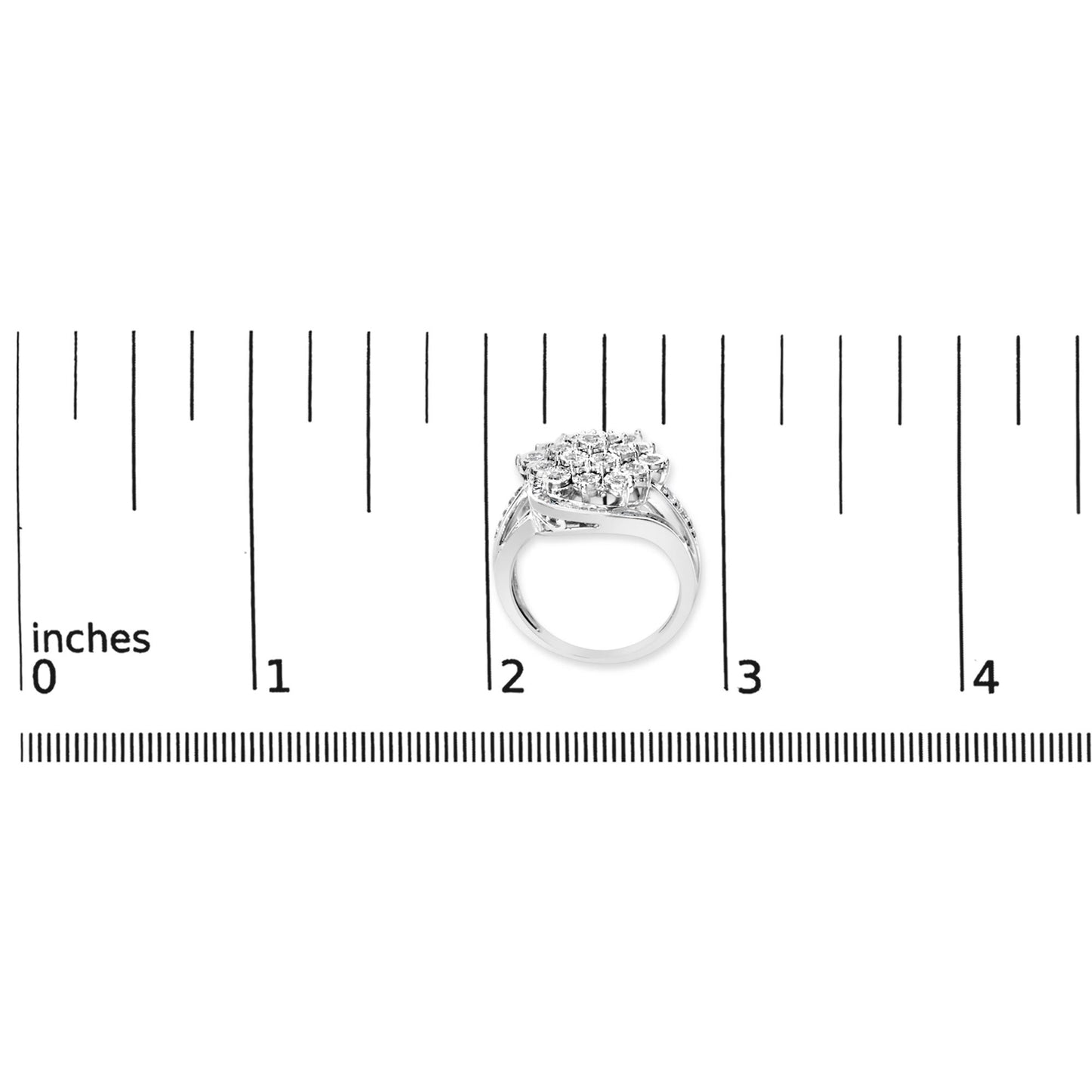 White metal ring with a cluster of round and baguette-shaped white gemstones viewed from the side, shown on a scale marked in inches.