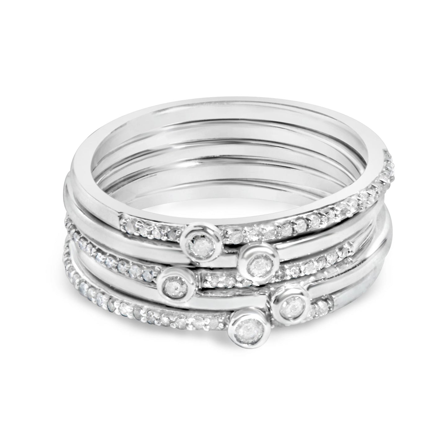 Close-up front angle of stacked white metal rings, each adorned with small white gemstones in prong settings and round white gemstones in bezel settings.