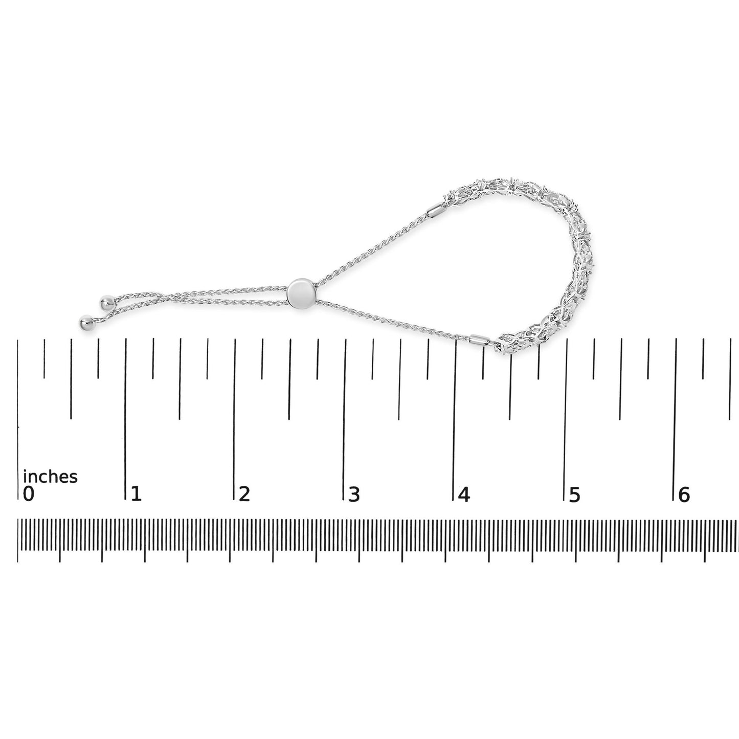 White bracelet with round white gemstones set in a channel setting, shown on a scale from a top-down angle.