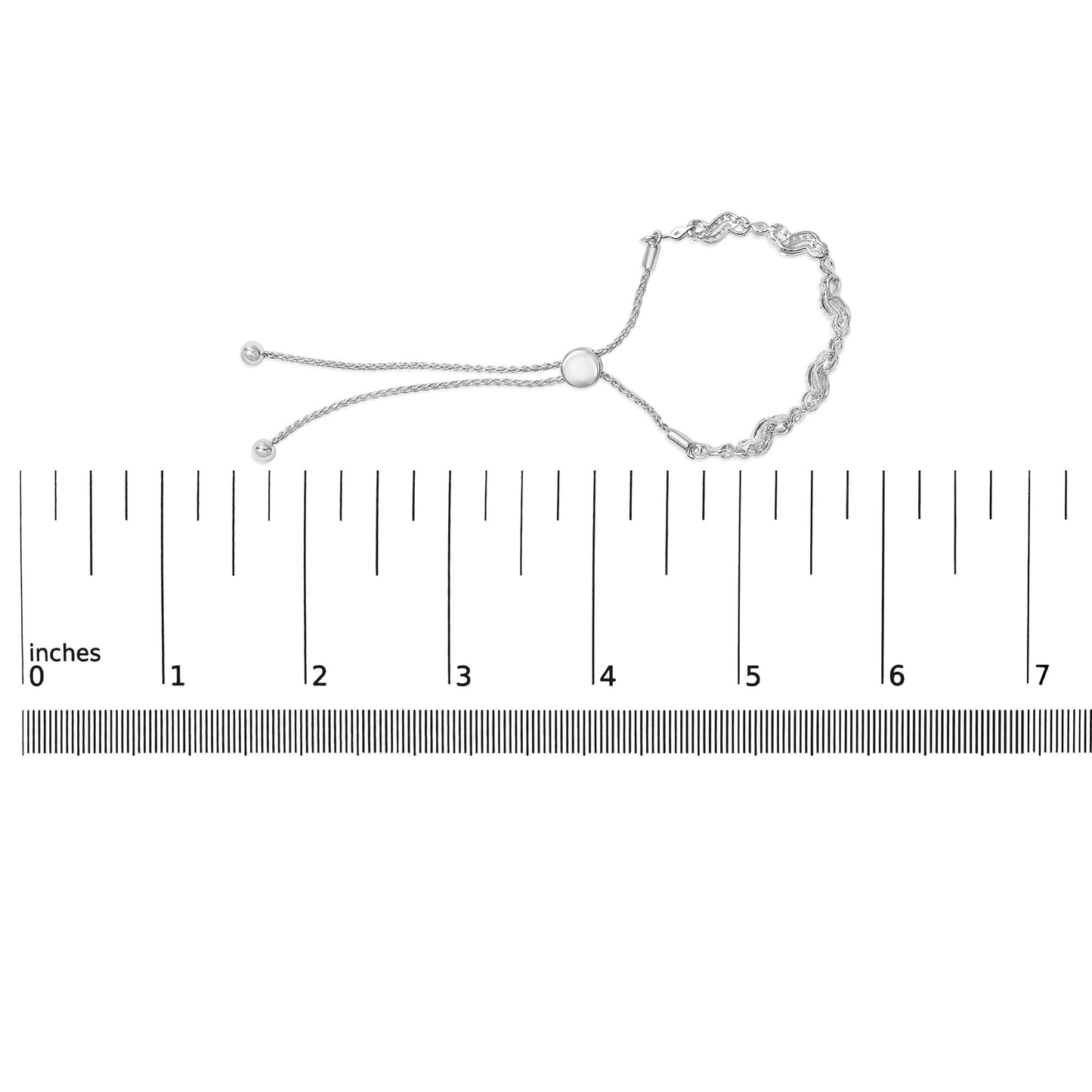 White metal bracelet with round white gemstones in prong settings, featuring a chain and adjustable sliding clasp, shown on a scale from a top view.