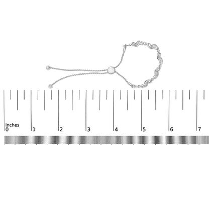 White metal bracelet with round white gemstones in prong settings, featuring a chain and adjustable sliding clasp, shown on a scale from a top view.