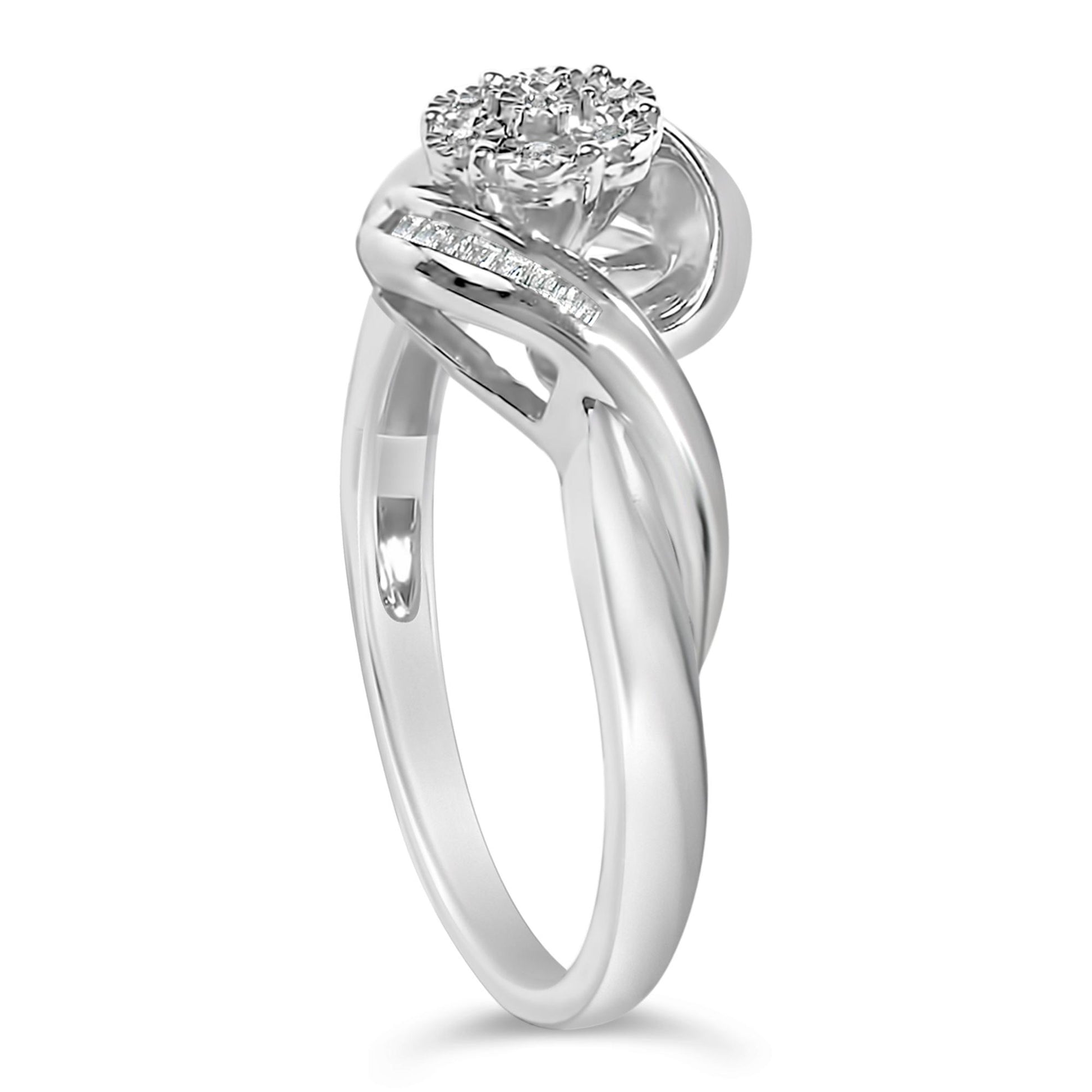White metal ring with a twisted band design, featuring a cluster of round white gemstones in prong settings at the top and a row of baguette-shaped white gemstones set in a channel along one side, shown in a close-up side angle.