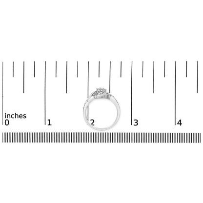 White ring with intertwined band design featuring white baguette and round gemstones, shown on a ruler scale from a side angle.