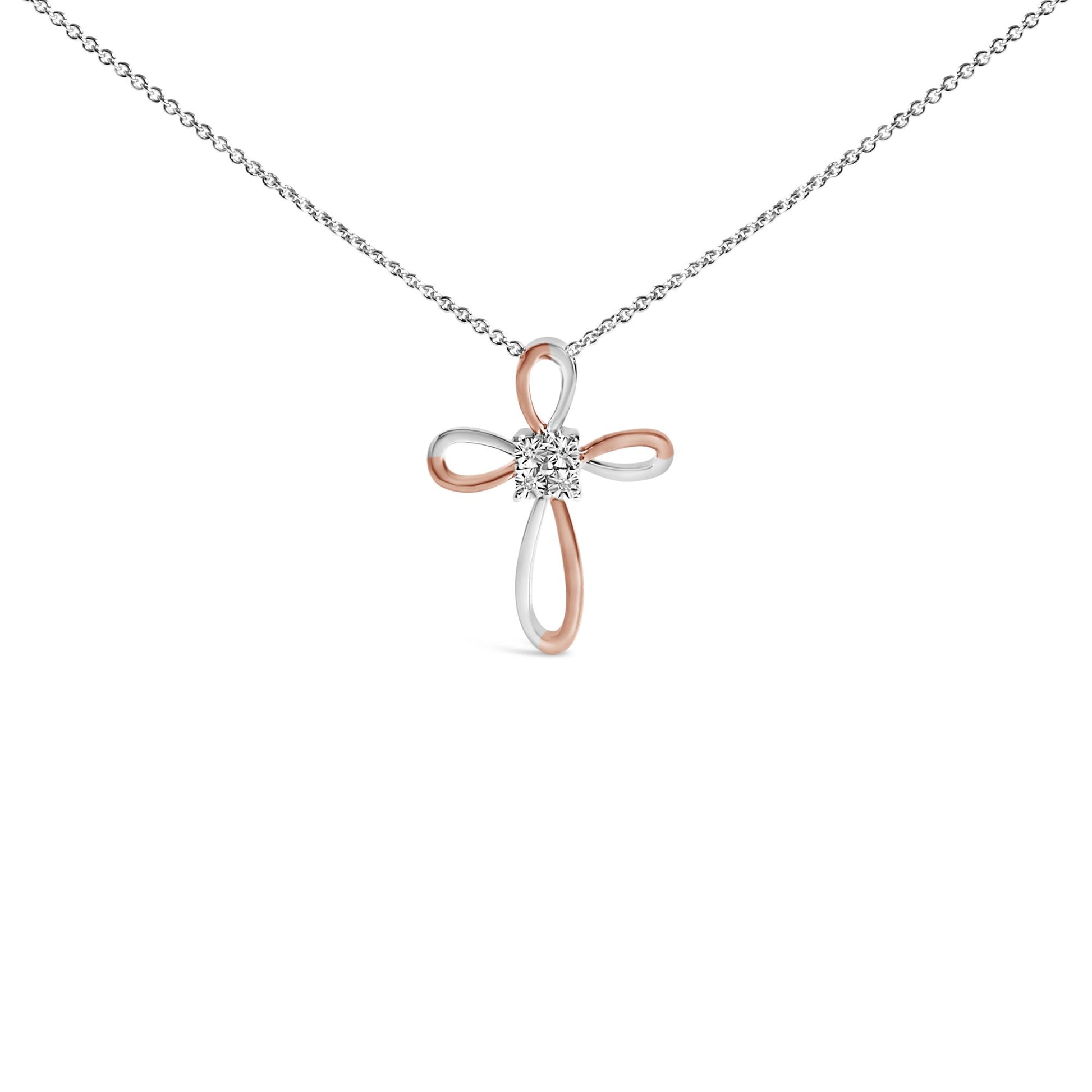 Front view of a white and rose colored metal cross-shaped necklace pendant with four round white gemstones in bezel settings at the center, shown against a white background.