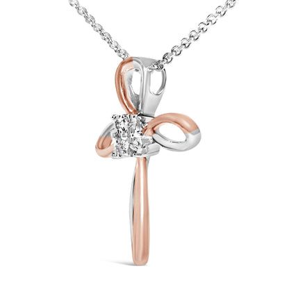 Front-facing close-up of a cross-shaped necklace pendant with intertwined white and rose metal loops, featuring four round white gemstones set in a square bezel setting at the center, hanging from a chain.