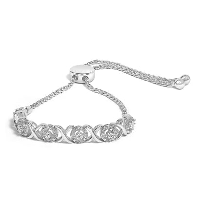 White metal bracelet with an adjustable sliding clasp, featuring alternating round white gemstones in prong settings and crisscross links, shown in a front angled view.
