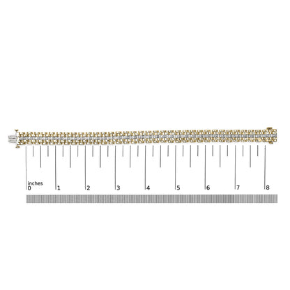 Bracelet with alternating yellow and white metal links set with round white gemstones in pave setting, shown flat on a measuring scale, top-down view.
