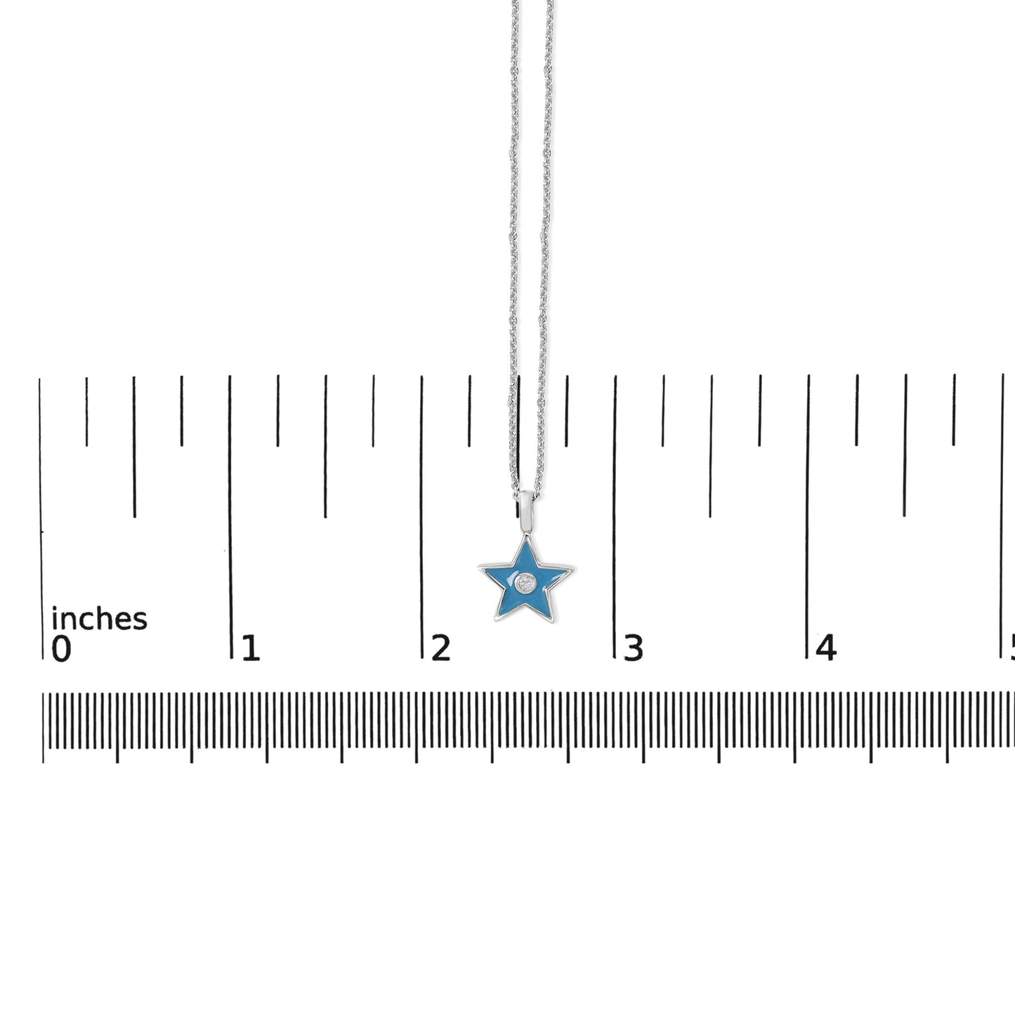 White metal necklace with a star-shaped blue pendant featuring a round white gemstone in bezel setting, shown on a scale from a top-down angle.