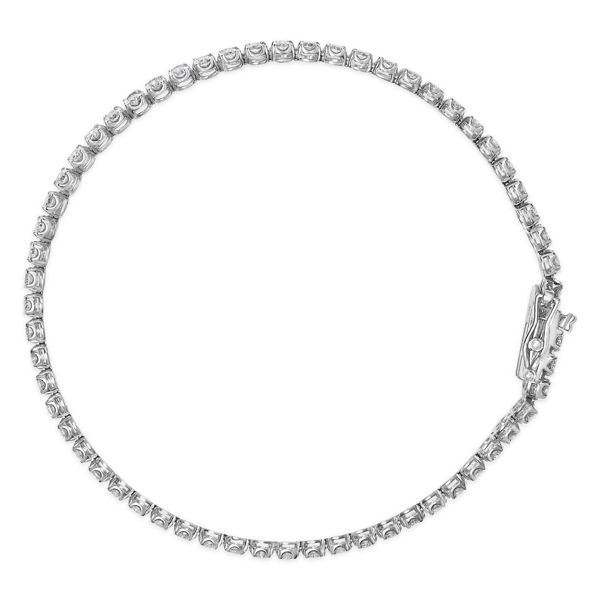 Top-down view of a white metal bracelet set with round white gemstones in four-prong settings along the entire length, featuring a clasp.