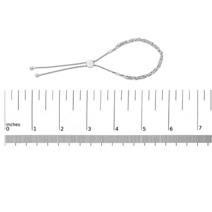 Bracelet with round white gemstones in prong settings on a white metal chain, shown on a scale, top-down view.