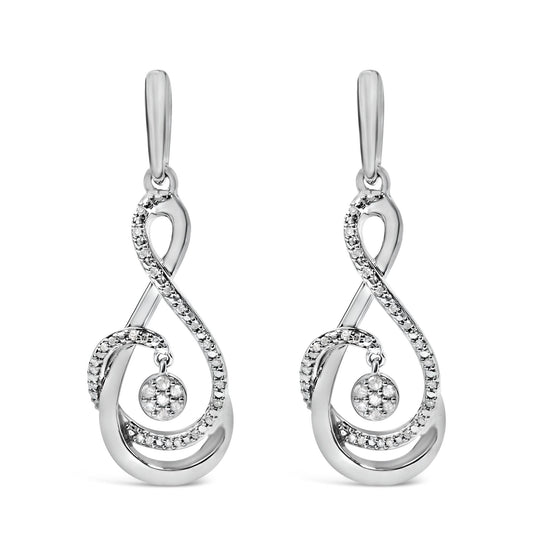 Front view of a pair of white metal earrings with a flowing, looping design accented by multiple round white gemstones in prong settings, including a central circular cluster that dangles.
