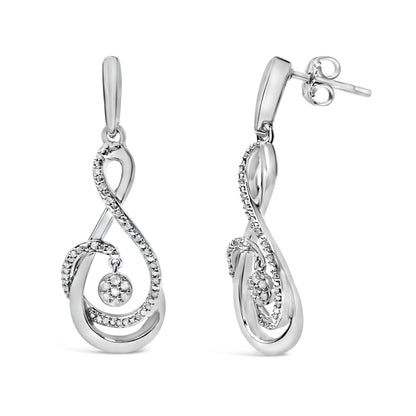 Pair of white metal drop earrings shown from front and side angles, featuring an elegant swirling design accented with small round white gemstones along the curves and a cluster of white gemstones in a circular setting hanging inside the swirl.