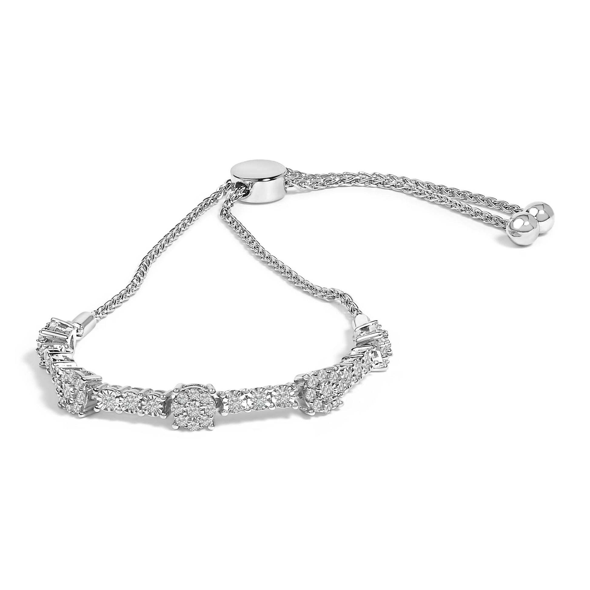 White metal bracelet with round shape white gemstones in prong setting, shown from a front angle on a white background.
