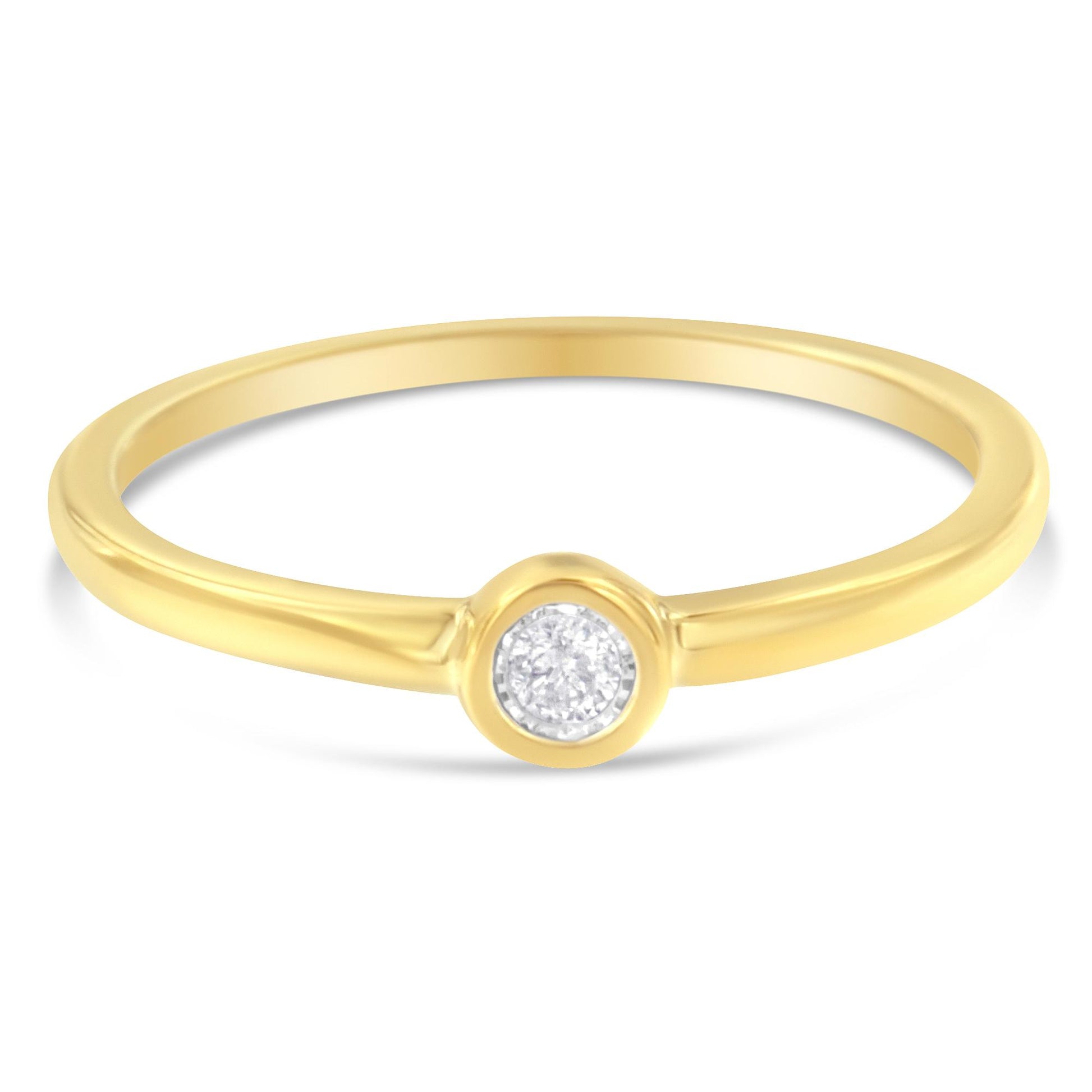 Front angle view of a yellow metal ring with a round white gemstone in a miracle setting.