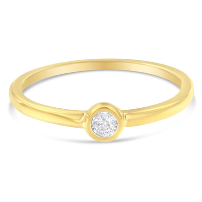 Front angle view of a yellow metal ring with a round white gemstone in a miracle setting.