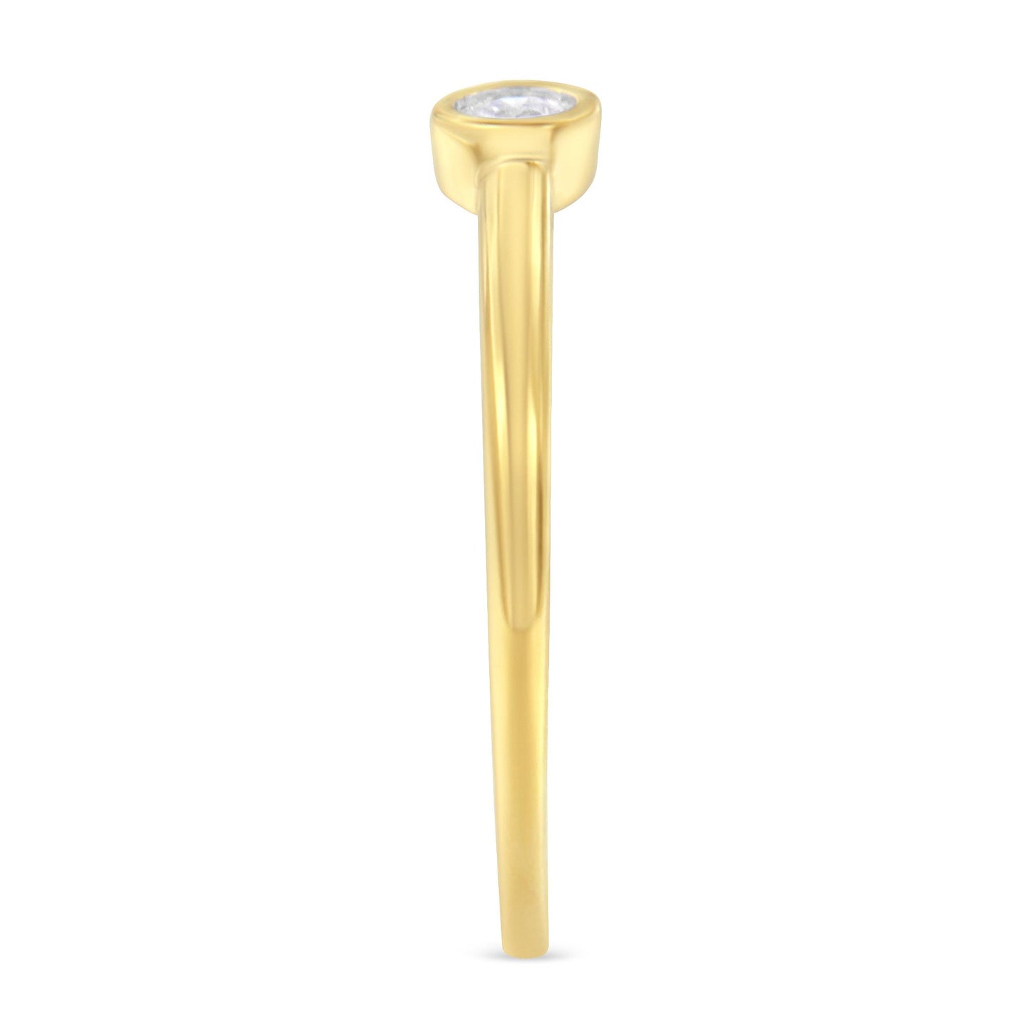 Side view of yellow metal ring with one round white gemstone in a bezel setting