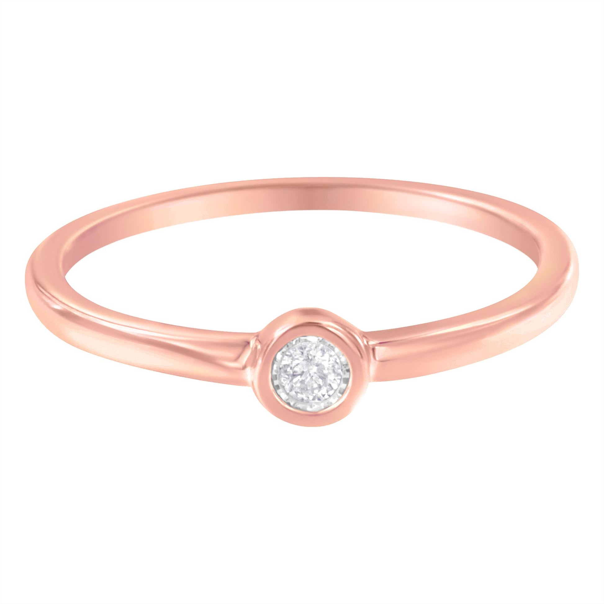 Close-up front view of a rose-colored ring with a single round white gemstone in a miracle setting.
